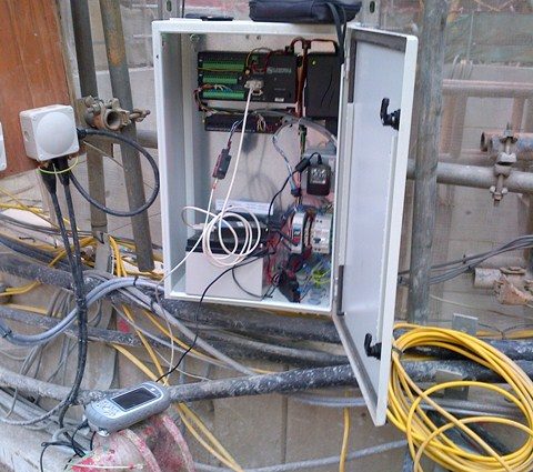 Datalogger installed on construction site surrounded by with high voltage cables