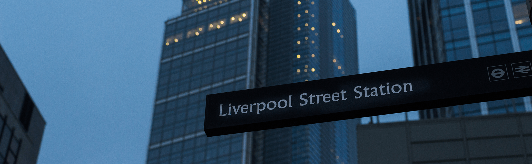 Liverpool street station sign and surrounding buildings