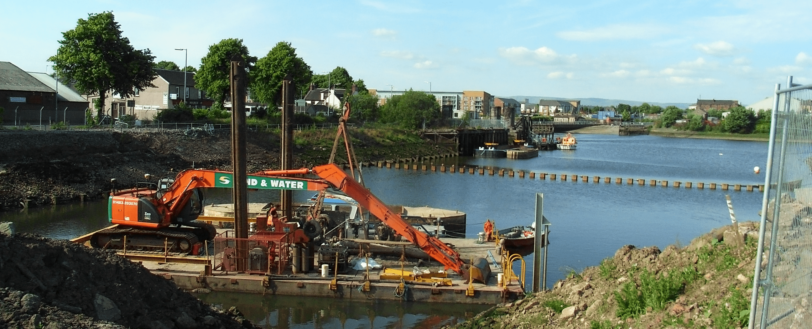 Excavator mounted on barge for dredging at Puzeoch basin